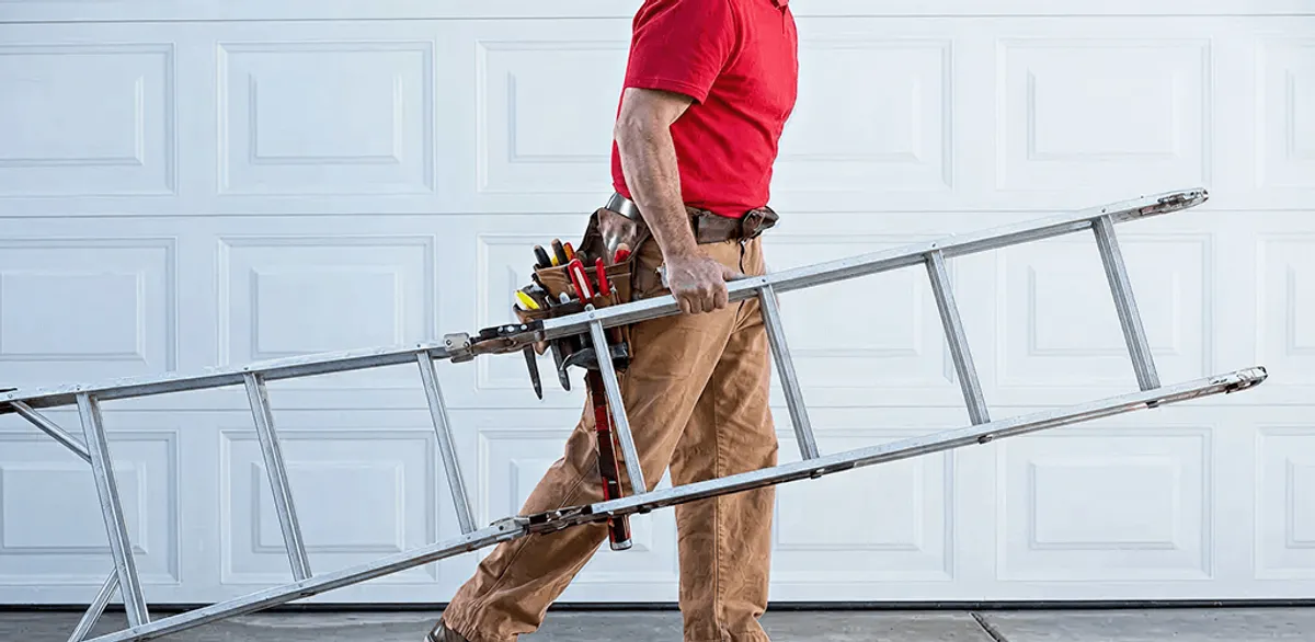 Garage door repair technician arriving with tools and ladder in Erie, PA