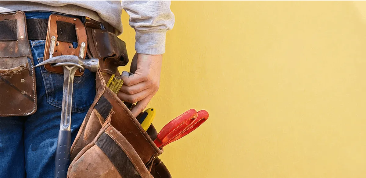 Handyman with tool belt ready for home repairs and maintenance in Erie, PA