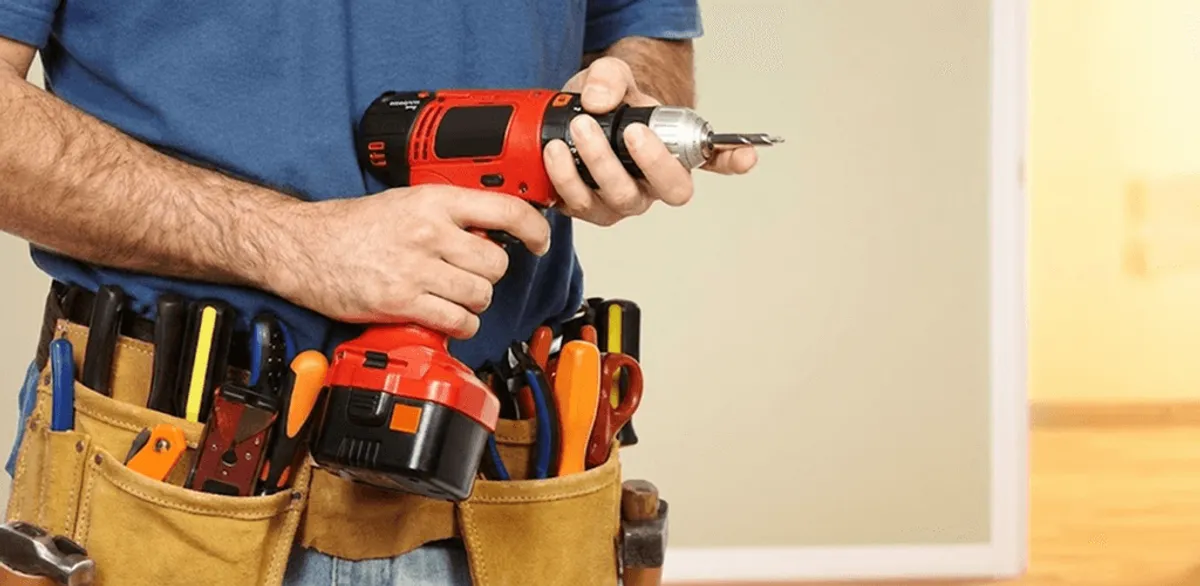Handyman holding a power drill for home repairs and installations in Erie, PA